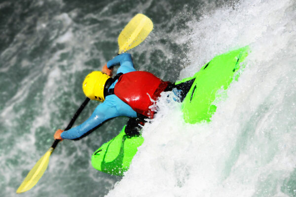 Kayaker paddling in a rotomolded kayak