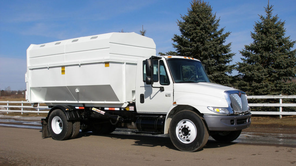 Roll off truck with a chipper box