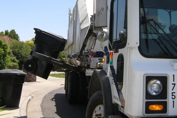Garbage truck picking up carts