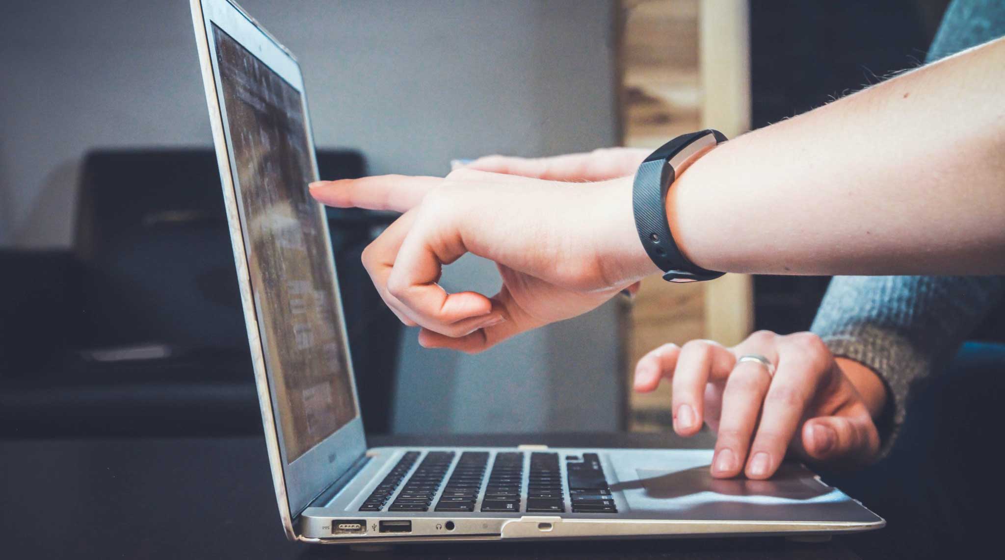marketer pointing at computer screen