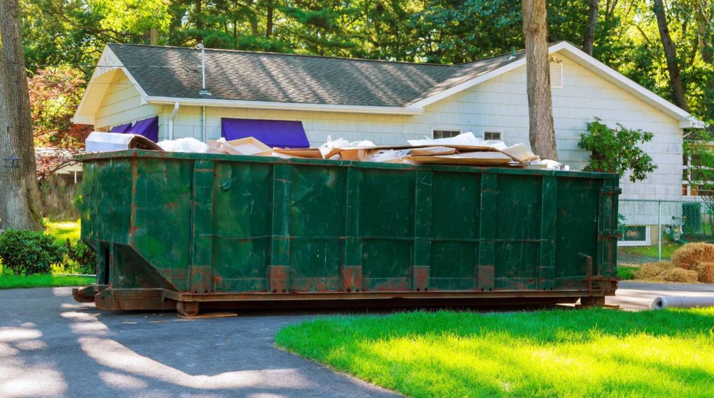 roll-off dumpster placed at a residential home renovation site