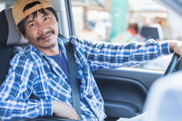 Roll off driver sitting behind the wheel of his pickup truck