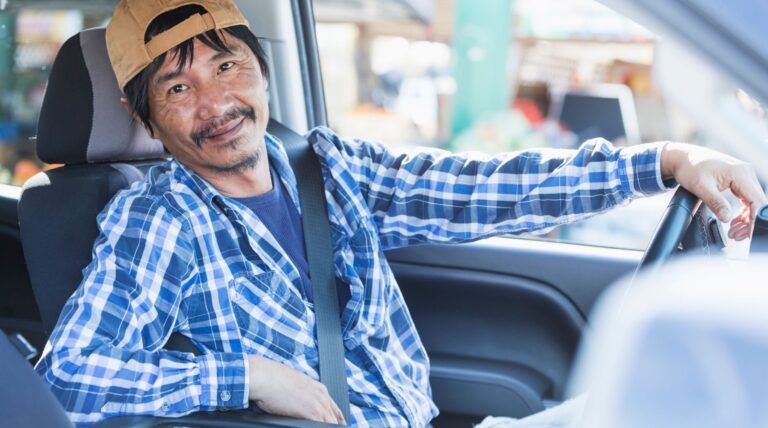Roll off driver sitting behind the wheel of his pickup truck