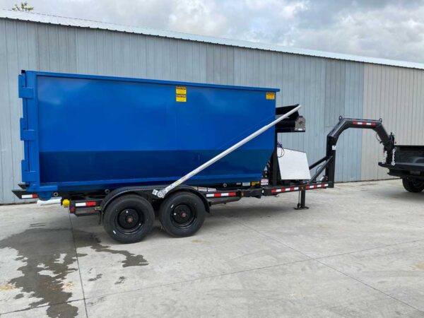 A roll off trailer with gooseneck hitch and a blue dumpster
