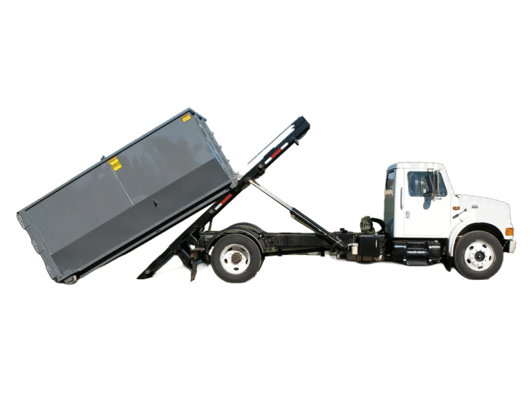 A white truck outfitted with a roll off hoist, dropping a gray dumpster at a job site